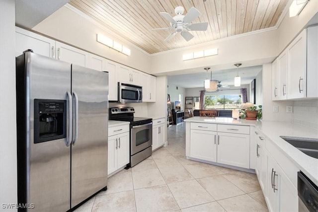 6025 Chardonnay Ln Unit 103, Naples, FL 34119 - kitchen featuring wood ceiling, crown molding, stainless steel appliances, and white cabinetry
