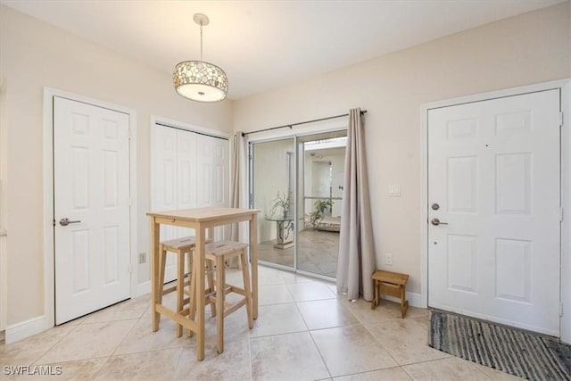 6025 Chardonnay Ln Unit 103, Naples, FL 34119 - dining area with baseboards and light tile patterned floors
