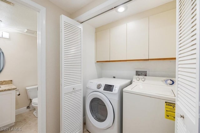 6025 Chardonnay Ln Unit 103, Naples, FL 34119 - clothes washing area featuring separate washer and dryer, cabinet space, and light tile patterned floors