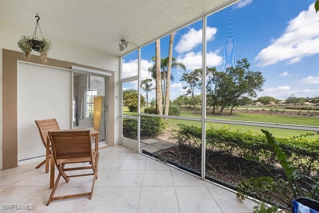 6025 Chardonnay Ln Unit 103, Naples, FL 34119 - sunroom / solarium with a textured wall, tile patterned floors, and a wall of windows