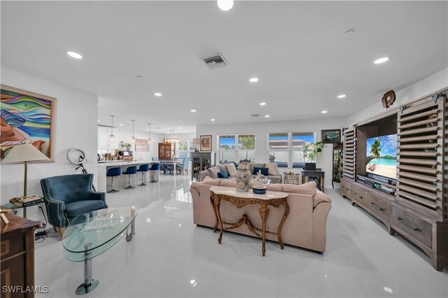 living area with visible vents and recessed lighting