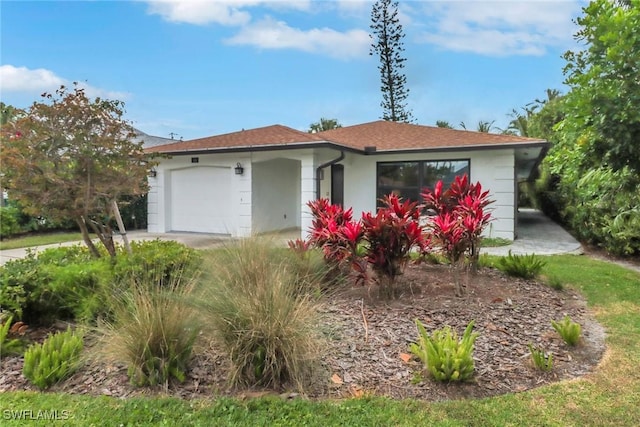 590 104th Ave N, Naples, FL 34108 - ranch-style house with an attached garage and stucco siding