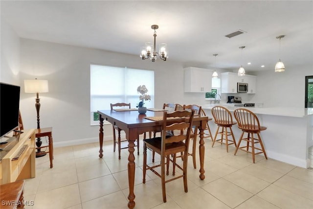 590 104th Ave N, Naples, FL 34108 - dining space with a chandelier and light tile patterned floors