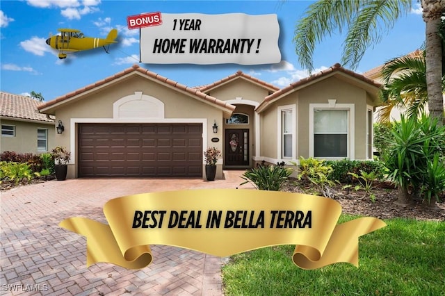 13599 Troia Dr, Estero, FL 33928 - view of front of home with an attached garage, decorative driveway, a tile roof, and stucco siding