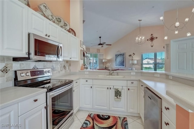kitchen featuring stainless steel appliances, a sink, ceiling fan, lofted ceiling, and light tile patterned floors