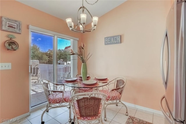 dining space with a chandelier, baseboards, and light tile patterned floors