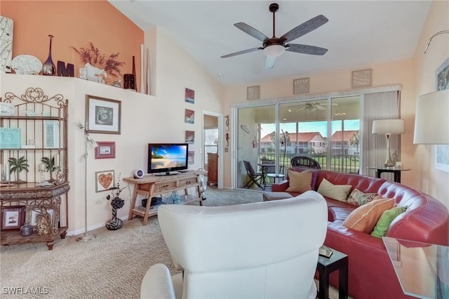 carpeted living area featuring lofted ceiling, a ceiling fan, and baseboards