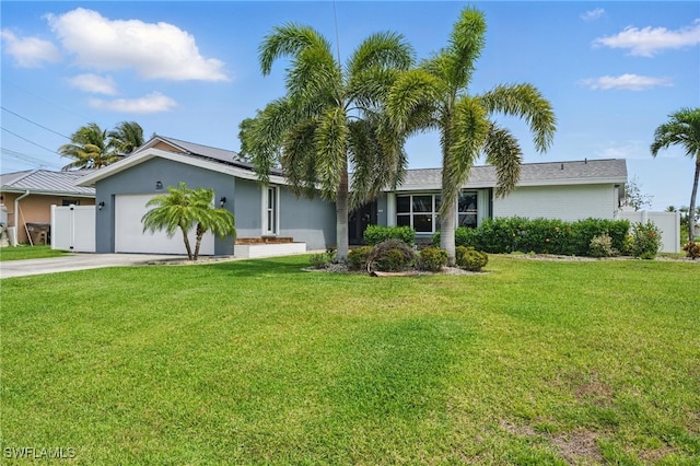 2941 SE 10th Pl, Cape Coral, FL 33904 - single story home with an attached garage, fence, driveway, and roof mounted solar panels