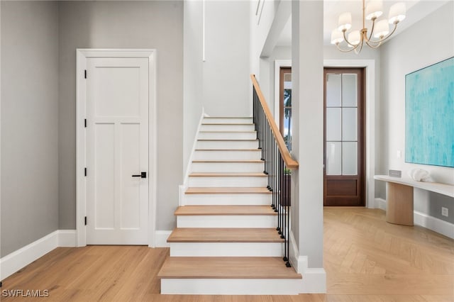 1179 Broad Ave N, Naples, FL 34102 - staircase with a chandelier and baseboards