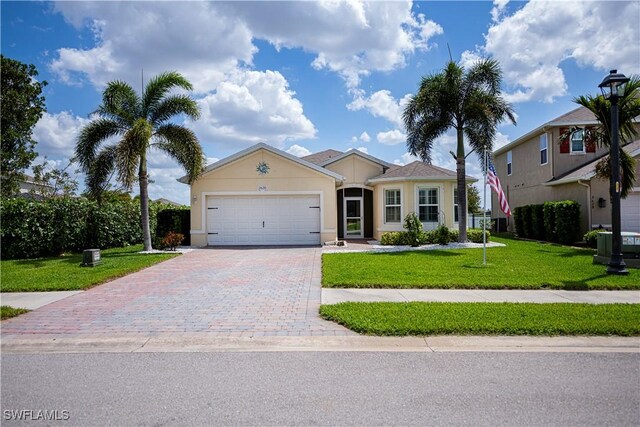 ranch-style home featuring an attached garage, driveway, a front yard, and stucco siding