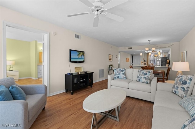 270 Naples Cove Dr Unit 3205, Naples, FL 34110 - living area featuring baseboards, light wood-style floors, visible vents, and ceiling fan with notable chandelier