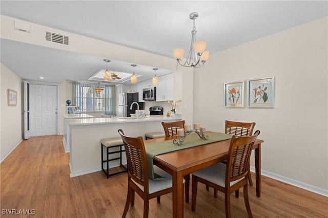 270 Naples Cove Dr Unit 3205, Naples, FL 34110 - dining room featuring an inviting chandelier, visible vents, baseboards, light wood-style floors, and recessed lighting