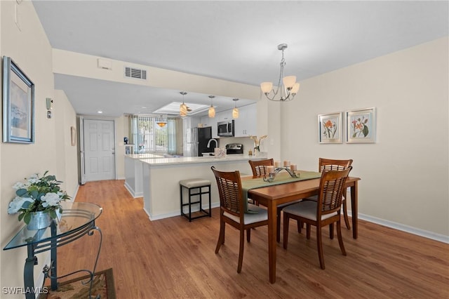 270 Naples Cove Dr Unit 3205, Naples, FL 34110 - dining space featuring light wood finished floors, a notable chandelier, baseboards, and visible vents