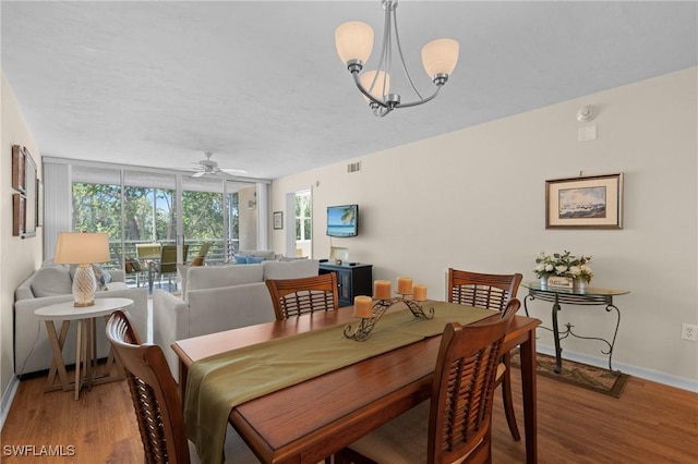 270 Naples Cove Dr Unit 3205, Naples, FL 34110 - dining area with ceiling fan with notable chandelier, a wealth of natural light, baseboards, and wood finished floors