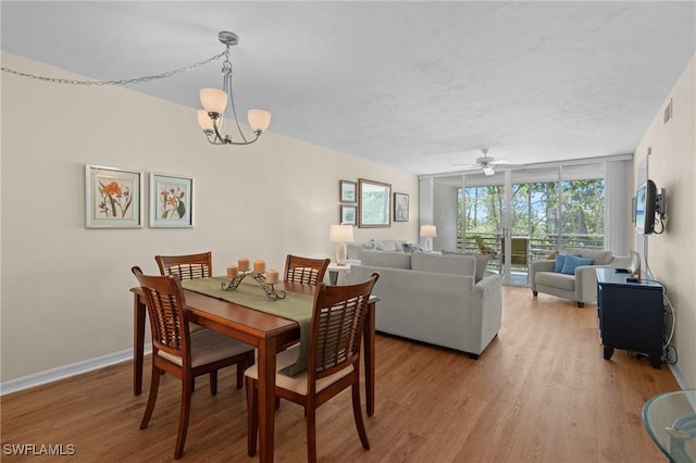 270 Naples Cove Dr Unit 3205, Naples, FL 34110 - dining space with wood finished floors, ceiling fan with notable chandelier, visible vents, baseboards, and floor to ceiling windows