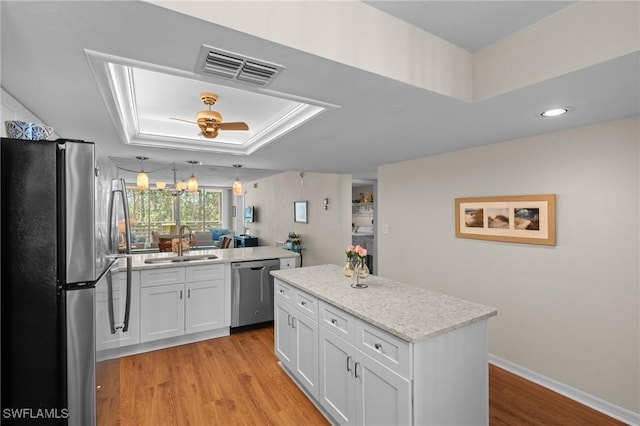 270 Naples Cove Dr Unit 3205, Naples, FL 34110 - kitchen with light wood-style flooring, visible vents, a sink, a raised ceiling, and appliances with stainless steel finishes