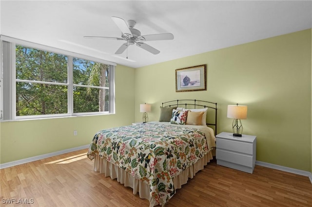 270 Naples Cove Dr Unit 3205, Naples, FL 34110 - bedroom featuring wood finished floors, baseboards, and multiple windows