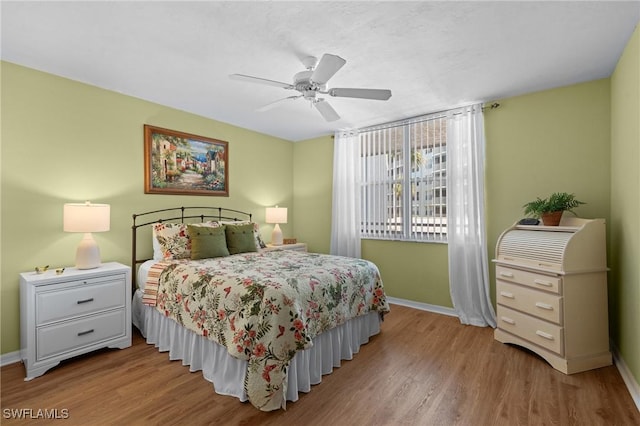 270 Naples Cove Dr Unit 3205, Naples, FL 34110 - bedroom with baseboards, a ceiling fan, and wood finished floors