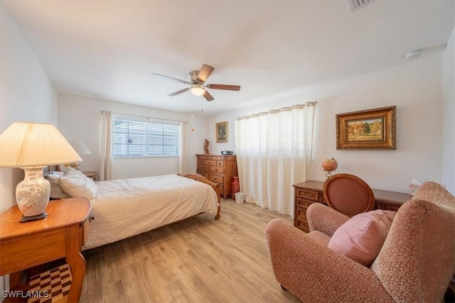 bedroom with a ceiling fan and light wood-style flooring