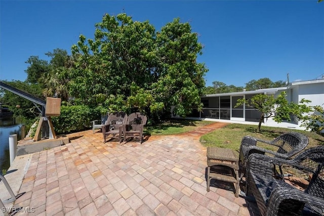 view of patio / terrace featuring a sunroom