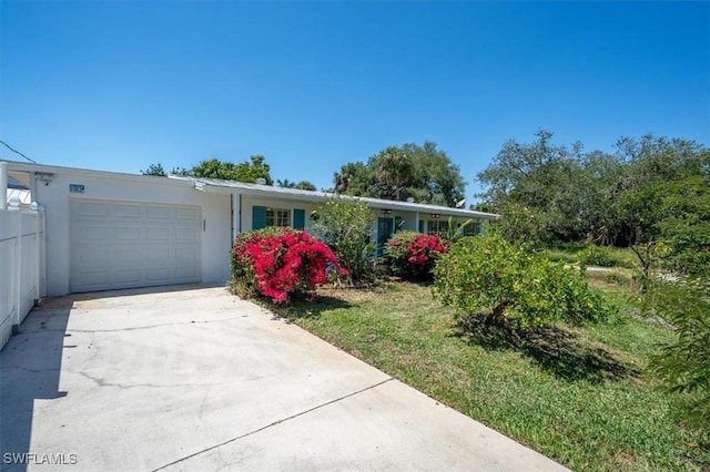ranch-style house with a garage, stucco siding, and concrete driveway