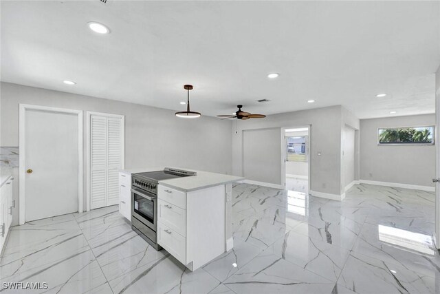 1423 Alwynne Dr, Lehigh Acres, FL 33936 - kitchen with white cabinetry, recessed lighting, marble finish floor, stainless steel stove, and light countertops