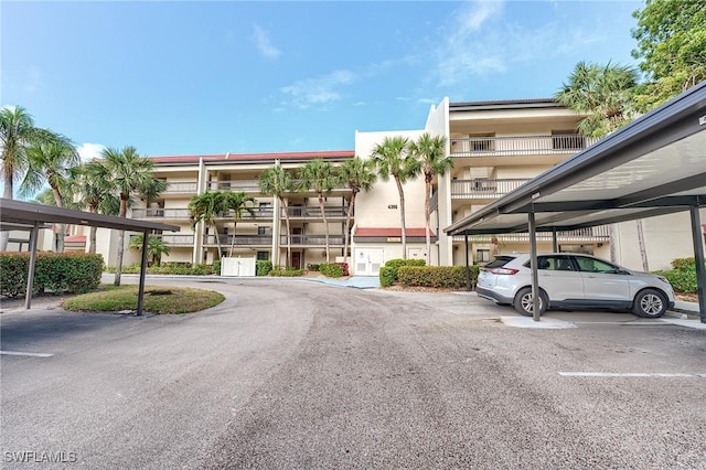 view of building exterior featuring covered parking