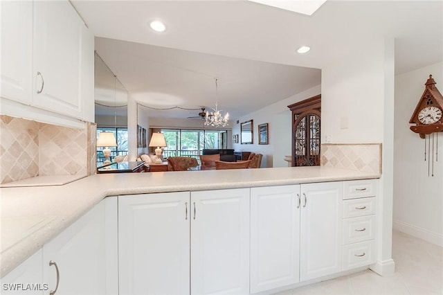 kitchen with recessed lighting, light countertops, white cabinets, and tasteful backsplash