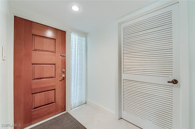 foyer entrance featuring baseboards, recessed lighting, and light tile patterned flooring