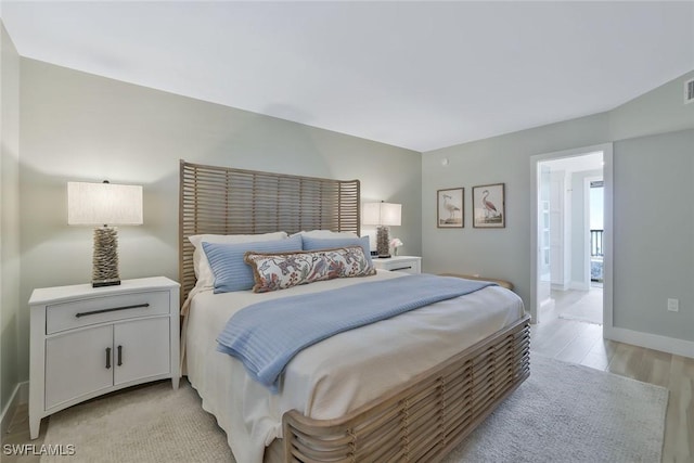 bedroom with visible vents, connected bathroom, baseboards, and light wood-type flooring