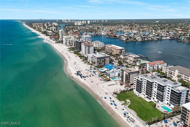 birds eye view of property with a water view, a view of the beach, and a city view