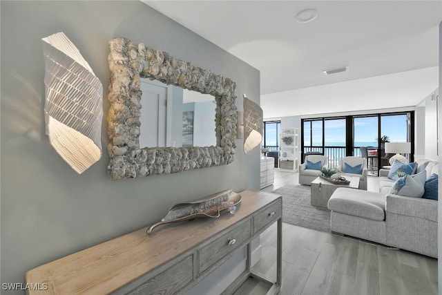 living room featuring visible vents and wood finished floors
