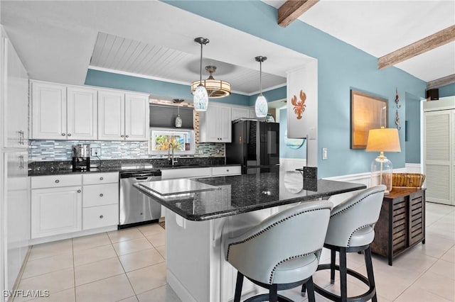 kitchen featuring light tile patterned flooring, beam ceiling, freestanding refrigerator, and dishwasher