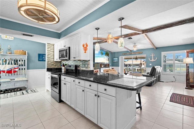kitchen featuring a ceiling fan, stainless steel appliances, light tile patterned floors, visible vents, and white cabinets