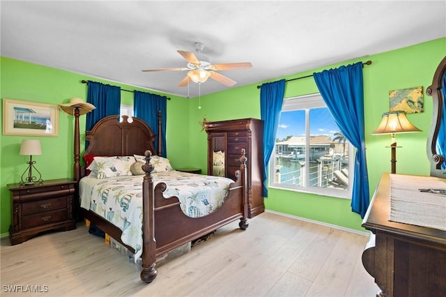 bedroom with baseboards, wood finished floors, and a ceiling fan
