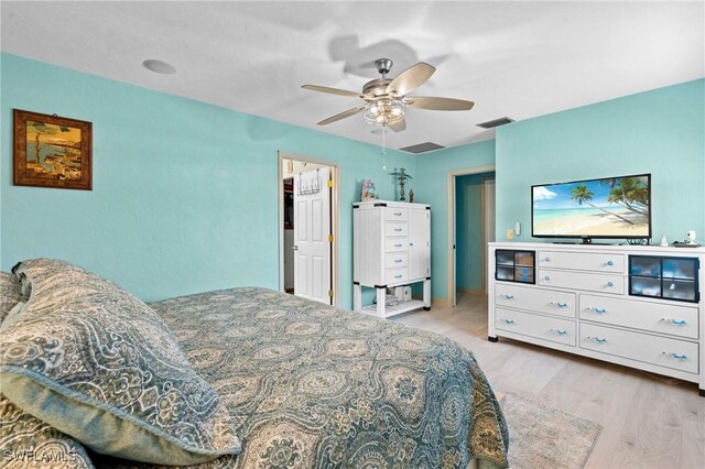 bedroom featuring visible vents, wood finished floors, and a ceiling fan
