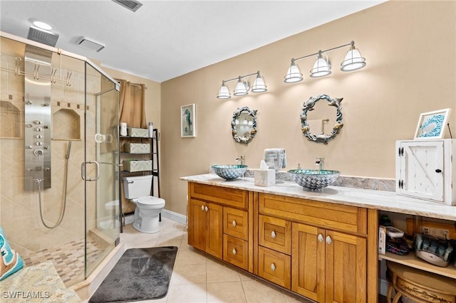 bathroom with a shower stall, tile patterned flooring, and a sink
