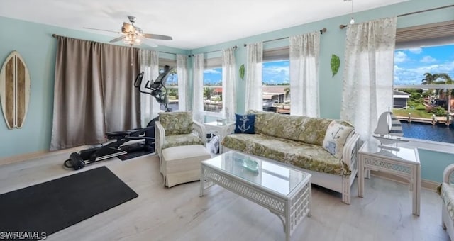 living area with ceiling fan and wood finished floors