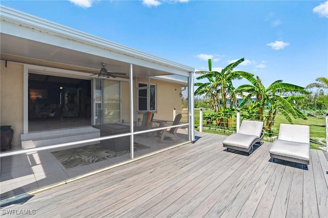wooden terrace with a ceiling fan