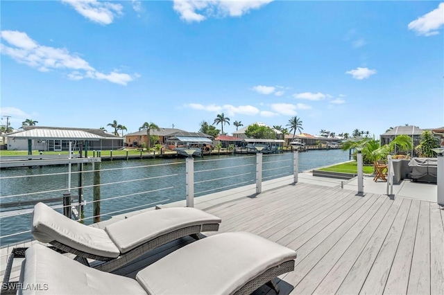 dock area featuring a water view and a residential view