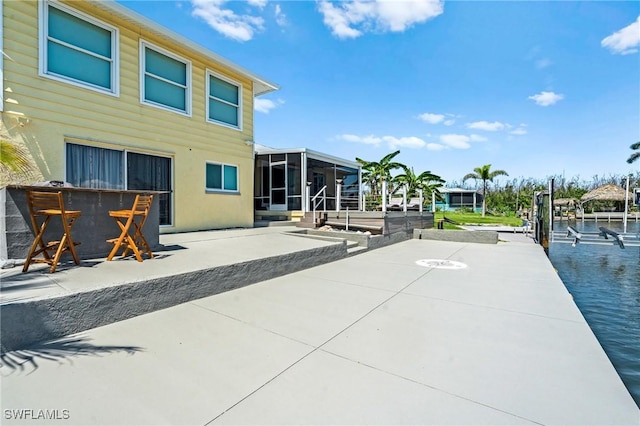 exterior space featuring a sunroom and a boat dock