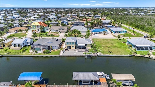 birds eye view of property featuring a water view and a residential view
