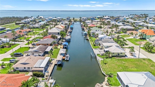 drone / aerial view featuring a residential view and a water view
