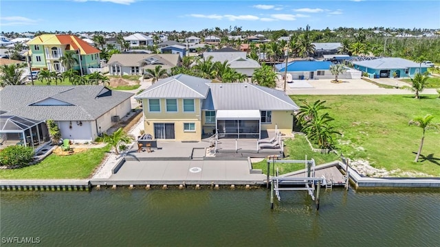 drone / aerial view featuring a residential view and a water view