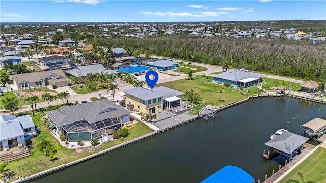 birds eye view of property with a residential view and a water view