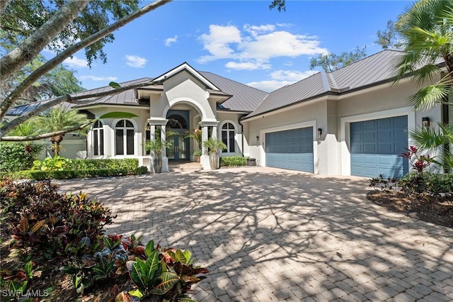 933 Barcarmil Way, Naples, FL 34110 - view of front of property featuring a garage, stucco siding, and decorative driveway