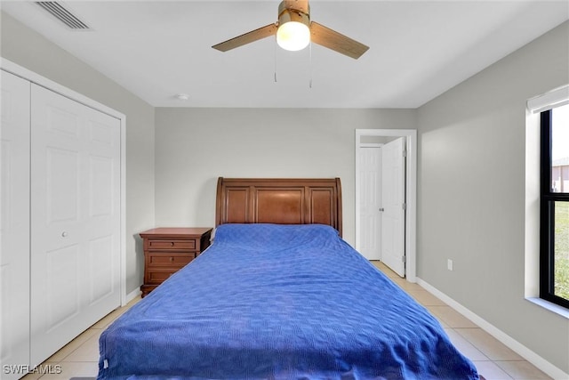 bedroom featuring a ceiling fan, light tile patterned floors, baseboards, and visible vents