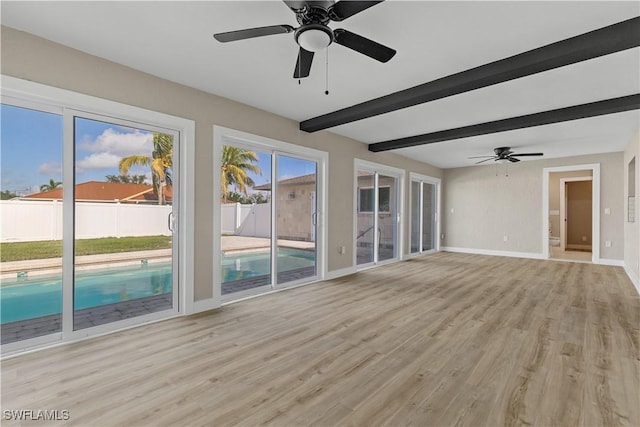1725 SE 3rd St, Cape Coral, FL 33990 - interior space with baseboards, light wood-type flooring, beamed ceiling, and ceiling fan