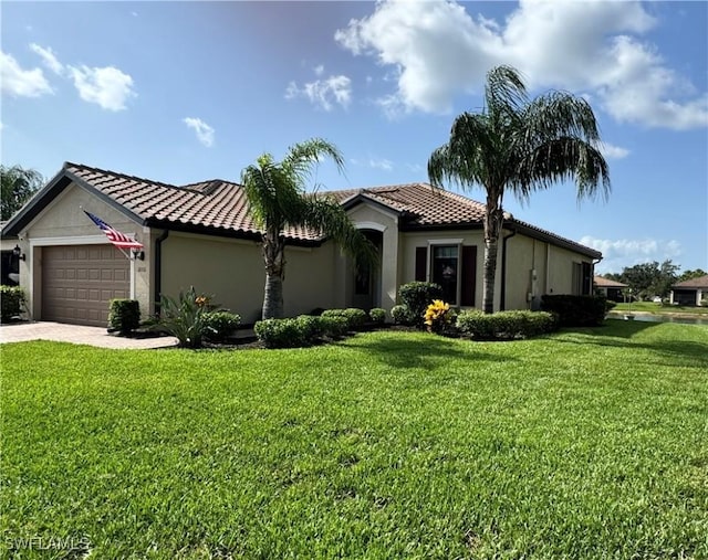 10331 Whispering Palms Dr, Fort Myers, FL 33913 - view of front facade with stucco siding, an attached garage, a front yard, a tiled roof, and decorative driveway