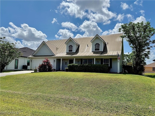 view of front of home with driveway, metal roof, a garage, and a front lawn